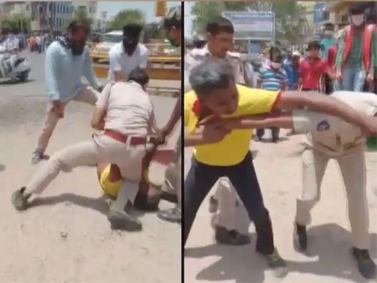 COVID-19 الهند: دبابيس شرطي رجل يستخدم الركبة